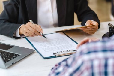Business people negotiating a contract. Human hands working with documents at desk and signing contract.