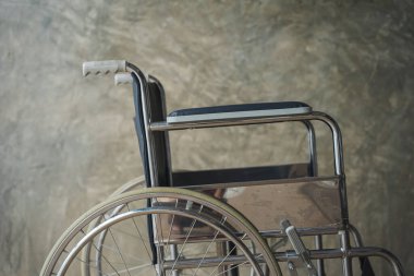 Close up view of empty wheelchair waiting for patient services with vintage filtered.
