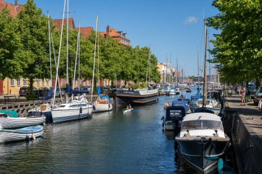 Copenhagen, Denmark - July 12, 2022: A canal and boats in Christianshavn district in the historic city centre.