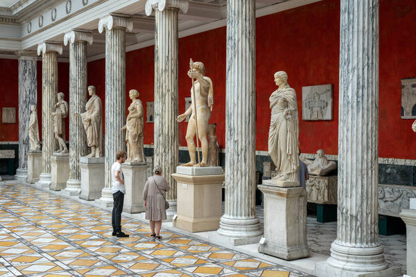 Copenhagen, Denmark - July 12, 2022: People looking at sculptures inside the New Carlsberg Glyptotek.