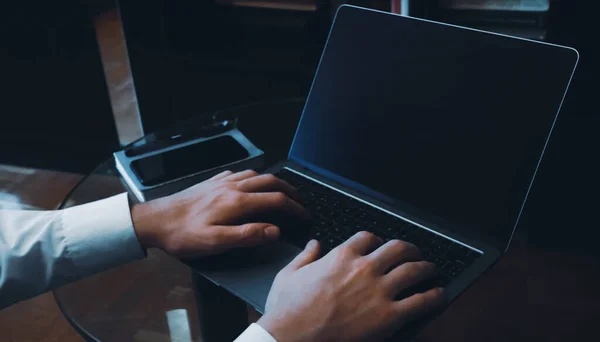 Working on laptop with blank screen closeup concept image. Rear view photo of male freelancer hands typing on notebook. Picture for web banner, landing page, blog, news and article with copy space