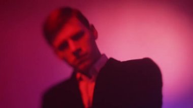 frowning face defocused man neon light portrait