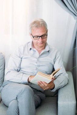 book leisure reading hobby home mature man couch