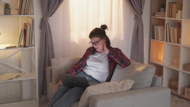 Видео чат интернет звонок ноутбук женщина диван домой — стоковое видео