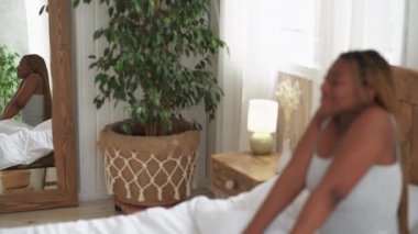 Günaydın yeni gün mutlu kadın yatakta geriniyor