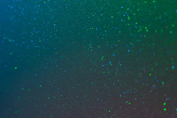 Glitter background bokeh light blue green grain — Stock Photo, Image