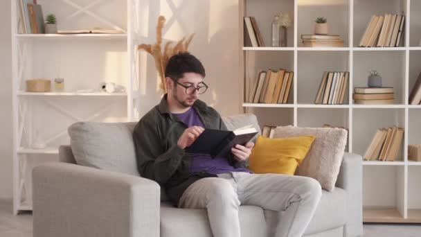 Finished book home reading man unhappy story sofa — Stock Video