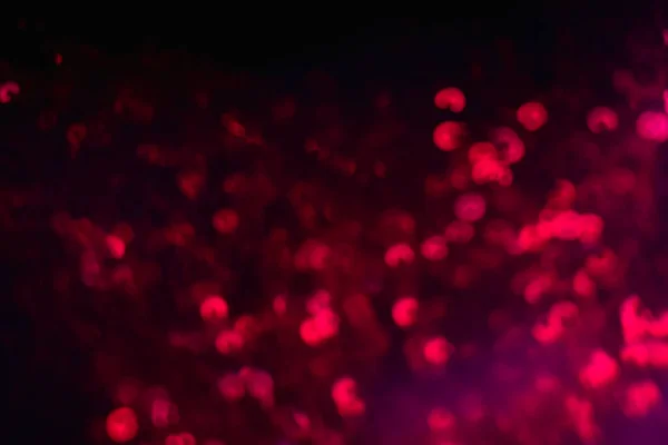 Neon bokeh luz borrão faíscas cor vermelha brilho lantejoulas — Fotografia de Stock