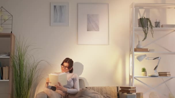 Couch reading cozy leisure home relaxing woman — Stock Video