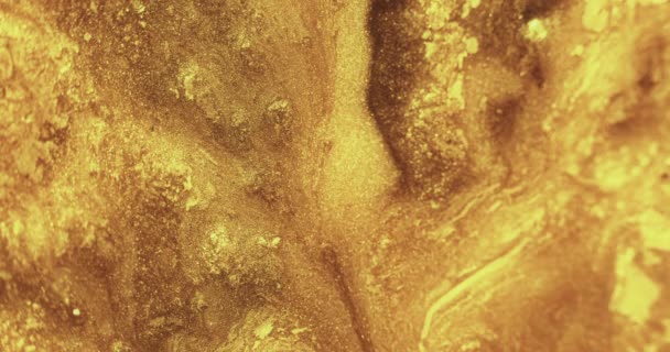 Fluxo de tinta glitter derretida vazamento fluido textura ouro — Vídeo de Stock