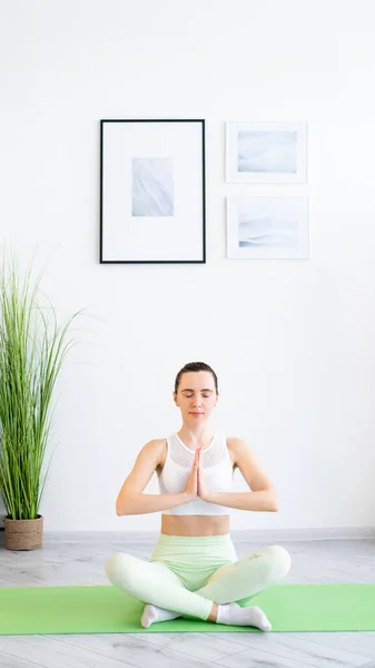 Meditating woman yoga practice body wellness home — стоковое фото
