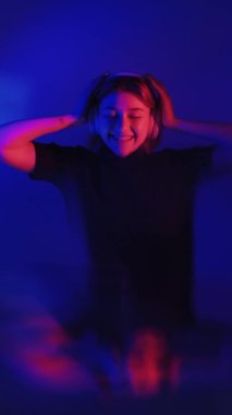music energy neon light girl dancing in headphones