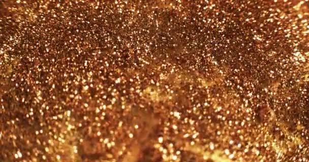 グリッター インクの流れ 黄金の背景 スパークリング流体波 黄色のオレンジ色の輝く塗料流出運動をぼかす 抽象アートテクスチャ Red Cinemaカメラで撮影 — ストック動画
