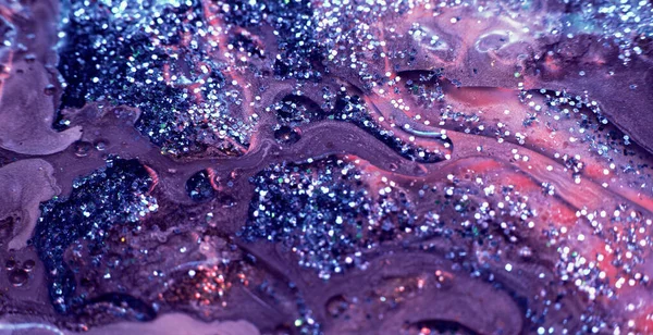Glitter paint flow. Ink mix. Floating shiny fluid. Defocused purple pink sparkling wet texture. Abstract art background shot on RED Cinema camera.