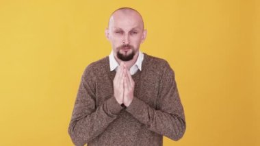 Yalvaran adam. Lütfen jest. Bumerang animasyonu. Yardım talep ediyorum. Çaresiz dua eden adam, portakal fotokopi alanına izole edilmiş elleri katlanmış gif döngüsüyle yardım istiyor..