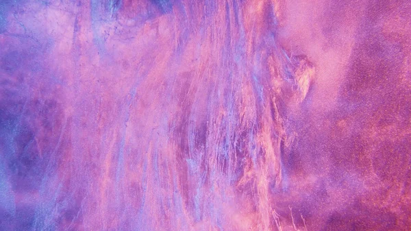 Glitter ink in water. Neon fluid texture. Fantasy waterfall. Fluorescent glowing purple pink blue color smoke cloud floating paint splatter abstract art background.