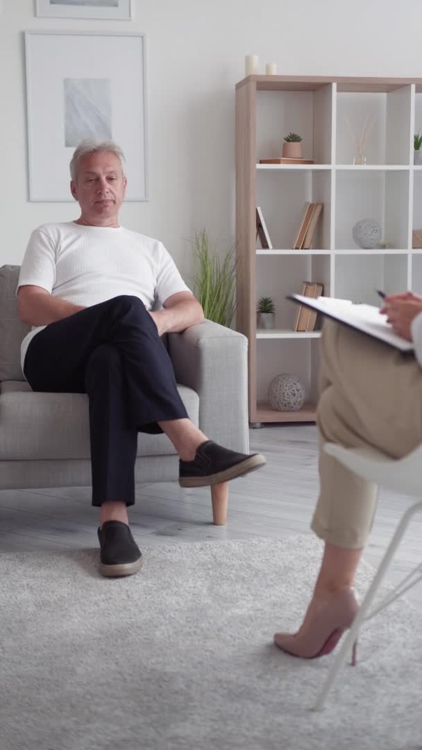 个人访谈 成功人士 会面交流自信的中年男子躺在沙发上 与现代室内垂直的女记者交谈 — 图库视频影像