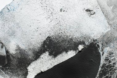 Old paper texture. Dirty art background for logo. Black paint stains grain splatter on white ripped edge sheet abstract surface with free space.