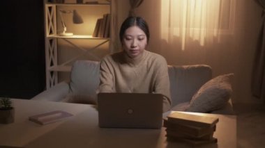 Student relief. Distance learning. Complete task. Satisfied tired girl finished studying closing laptop leaving workplace at modern home interior.
