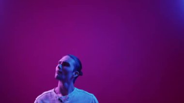 Neon light people. Advertising background. Information presentation. Curious inspired guy reading agree with invisible text isolated on pink purple blue color gradient copy space.