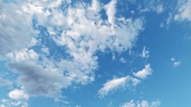 Sky magic. Change weather. Aerial view. Clear blue heaven covering with white fluffy and dark rainy clouds flying through fast motion.