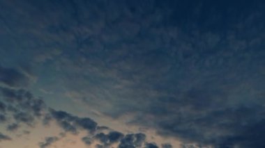 Sunrise sky. Wonderful world. Nature beauty. Dark blue early morning heaven with fluffy clouds flying away and changing to daylight fast motion.