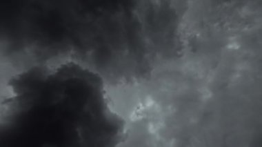Cloudy sky. Thundery weather. Gloomy day. Misty view of dark gray fluffy clouds flying through in heaven time lapse motion.