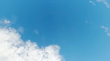 Beautiful sky. Nice weather. Aerial view. Clear blue heaven highness with white fluffy clouds flying away fast motion.