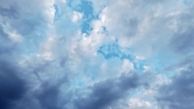 Cloudy sky. Change weather. Boundless atmosphere. White gray dense clouds covering blue heaven flying through.