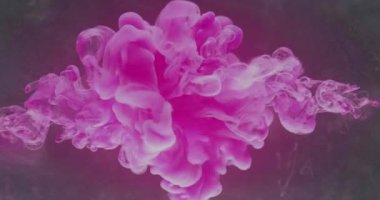 Color explosion. Ink water splash. Logo opener effect. Neon pink fluid drop mix on dark glitter mist cloud texture abstract art background shot on RED Cinema camera.
