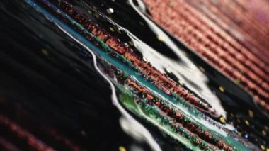 Fluid art. Mixing colors. Advertising background. Dark glittered liquid paint floating on brown hollow rows in macro shooting.