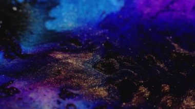 Ink floating. Glitter fluid flow. Shimmering night sea. Defocused neon blue black gold purple color wet paint spreading grain texture abstract art background.