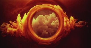 Smoke round frame. Ink water flow. Occult wheel. Hot blast. Orange yellow color fume cloud glow in circle whirl on dark black abstract background shot on RED Cinema camera.