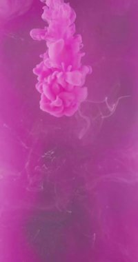 Ink mix in water. Color vapor. Chemical reaction. Neon pink liquid paint dissolving on vibrant fume cloud texture abstract art background shot on RED Cinema camera.