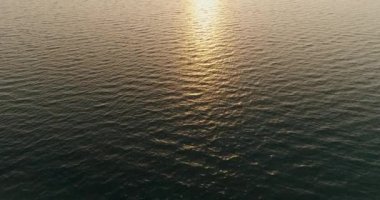 Seascape background. Aerial shot. Sea waves texture. Peaceful nature panorama. Ocean conservation. Water surface soothing motion with orange sunlight reflection drone view.
