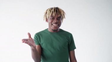 Blowing kiss. Macho man. Meme expression. Smiling playful black guy sending love with hand isolated white looped video.