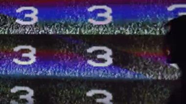 Mind control. TV propaganda. Brainwash manipulation. Silhouette of hypnotized shirtless man in analog static noise glitch television channel countdown projector light.