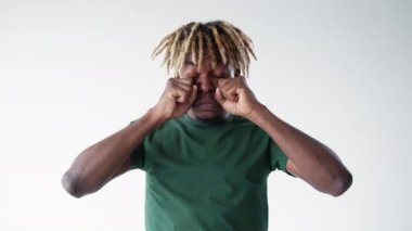 Crying gesture. Meme man. Childish sadness. Gloomy funny black guy showing cleaning tears isolated white looped video.