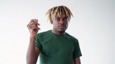 Cash gesture. Black man. Meme expression. Hipster guy shifting fingers holding hand up waiting for getting money isolated white looped video.