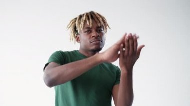 Drop money. Black man. Meme gesture. Confident hipster guy shifting hands spreading invisible cash isolated white looped video.