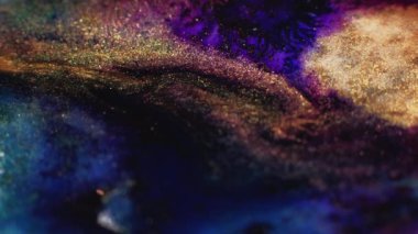Sparkling fluid mix. Glitter ink flow. Suminagashi texture. Blur gold black blue pink color paint floating on dark abstract art background.
