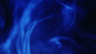Color smoke background. Vapor cloud. Reveal transition. Fantasy mist. Defocused neon blue glowing steam swirl motion on dark night black abstract texture for intro.