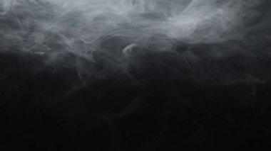Steam texture. Vapor flow motion. Gray fog floating. White transparent smoke spreading on dark night black abstract background for intro.