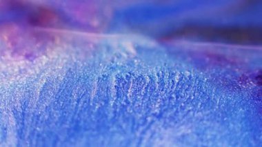 Bokeh glitter background. Sparkling ink. Fantasy waterfall. Defocused neon blue purple pink color shiny sequin scattering abstract grain texture.