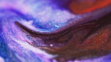 Ink floating. Glitter fluid flow. Shimmering sea wave. Defocused blue red purple color wet paint spreading grain texture abstract art background.