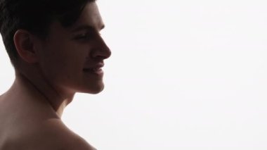 Profile man face. Skin treatment. Dermatology therapy. Portrait of relaxed shirtless smiling handsome guy with mole marks on cheek isolated on white copy space background.