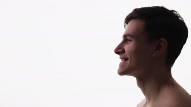 Smiling guy face. Skincare cosmetology. Health wellbeing. Profile portrait of satisfied shirtless handsome brunet man with clean skin isolated on white copy space background.