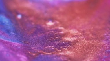 Color ink splash. Glitter fluid texture. Paint mix flow. Defocused gold orange neon pink blue wet dye spatter motion abstract art background.