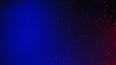 Neon bokeh light. Snow falling. Winter sparkles. Defocused blue pink color gradient flakes motion on dark glowing abstract decorative background for intro.