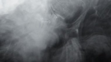Smoke texture. Fume cloud motion. Glowing steam swirl. Air pollution. White mist floating on dark night black abstract background for intro.